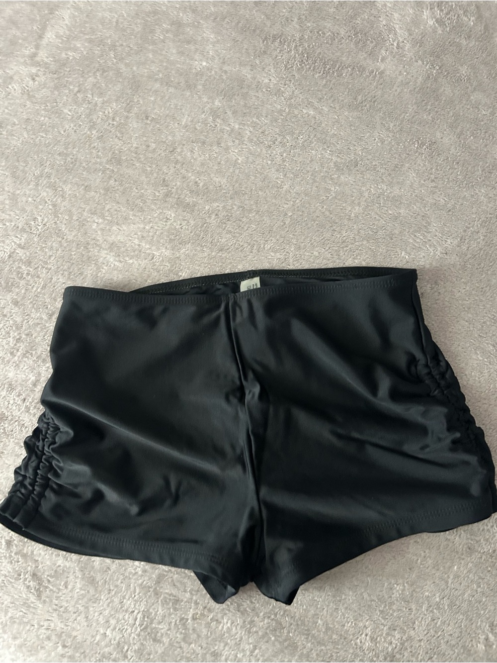 Low waisted black swim shorts with ruched detailing #swimwear #beachwear #summer